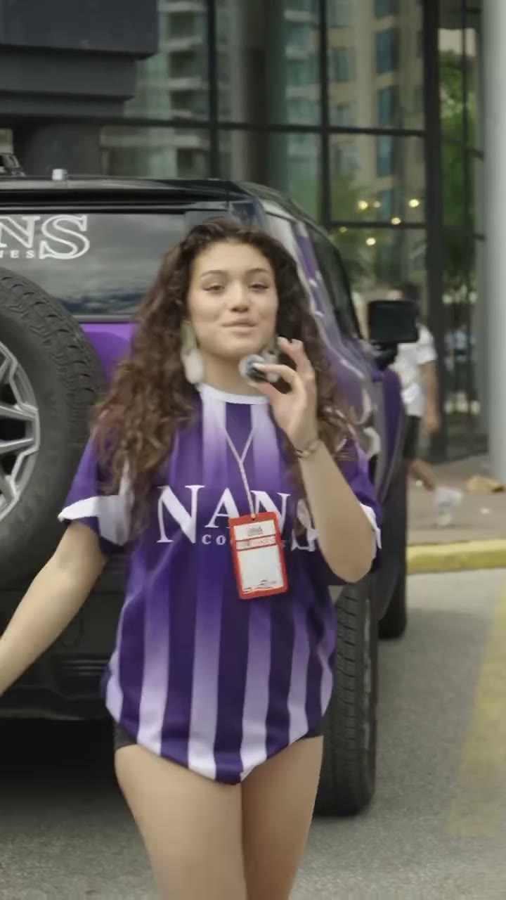 Nan's Cookies street team member in a NANS jersey beside the NANS truck